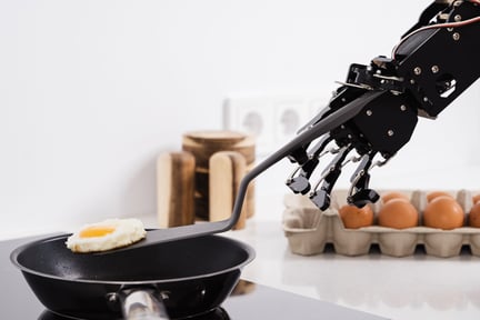 real-robot-hand-and-frying-pan-with-fried-egg-2023-11-27-05-20-10-utc
