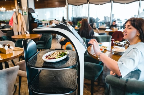 robot-waiter-serve-food-at-modern-restaurant-table-2023-11-27-05-30-12-utc